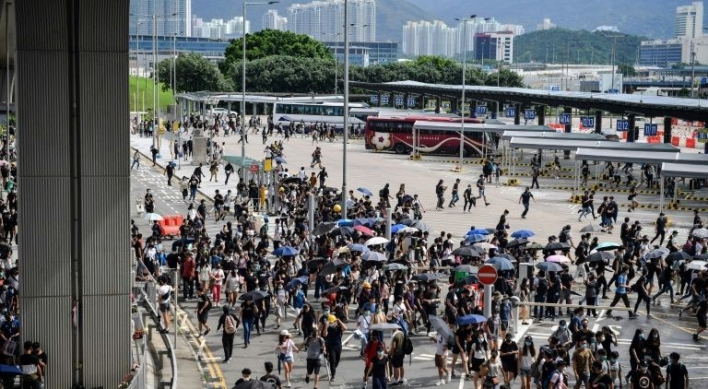 Hong Kong protesters target airport as city mops up
