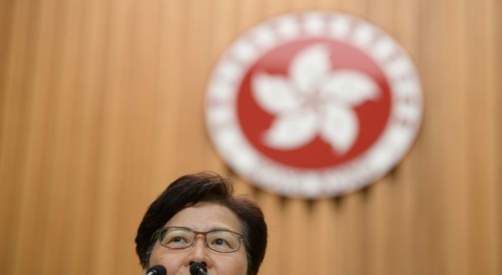 Hong Kong leader insists she will stay on