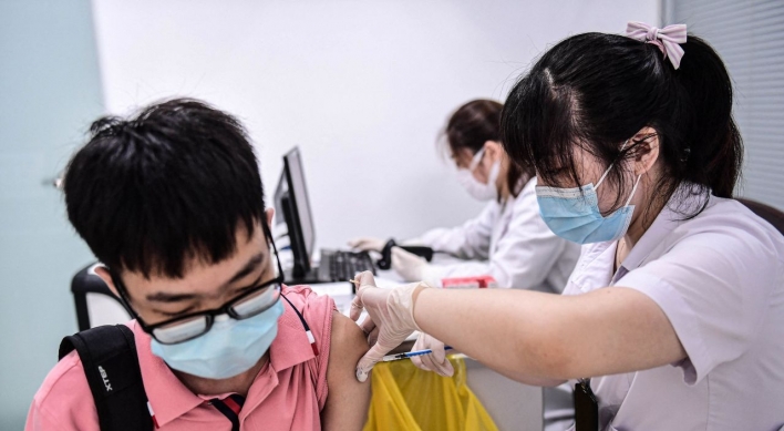 Chinese cities test millions as virus cases surge