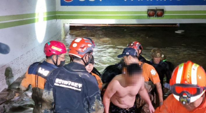 Two in flooded basement parking lot found alive