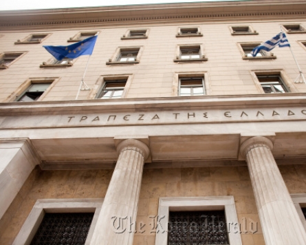 Greece hit by new downgrade on debt fears
