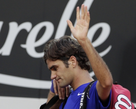 Federer stunned, Nadal shrugs off fever in Rome