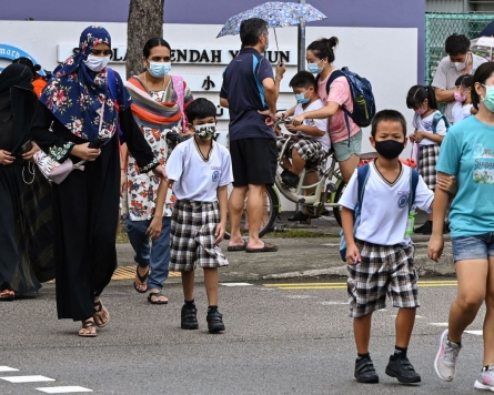 Singapore shuts schools, Taiwan bars foreigners to battle outbreaks